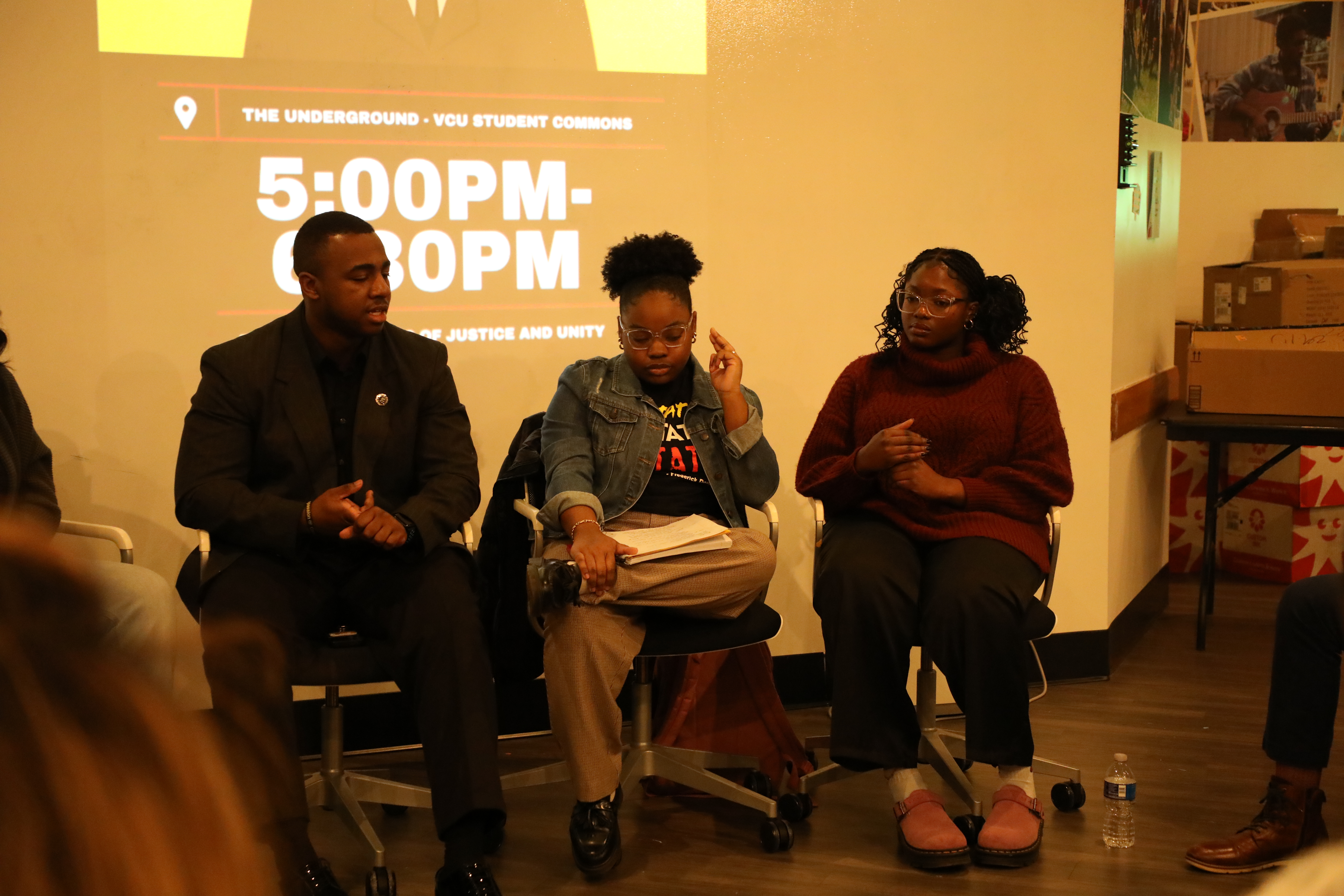 three people sitting down talking